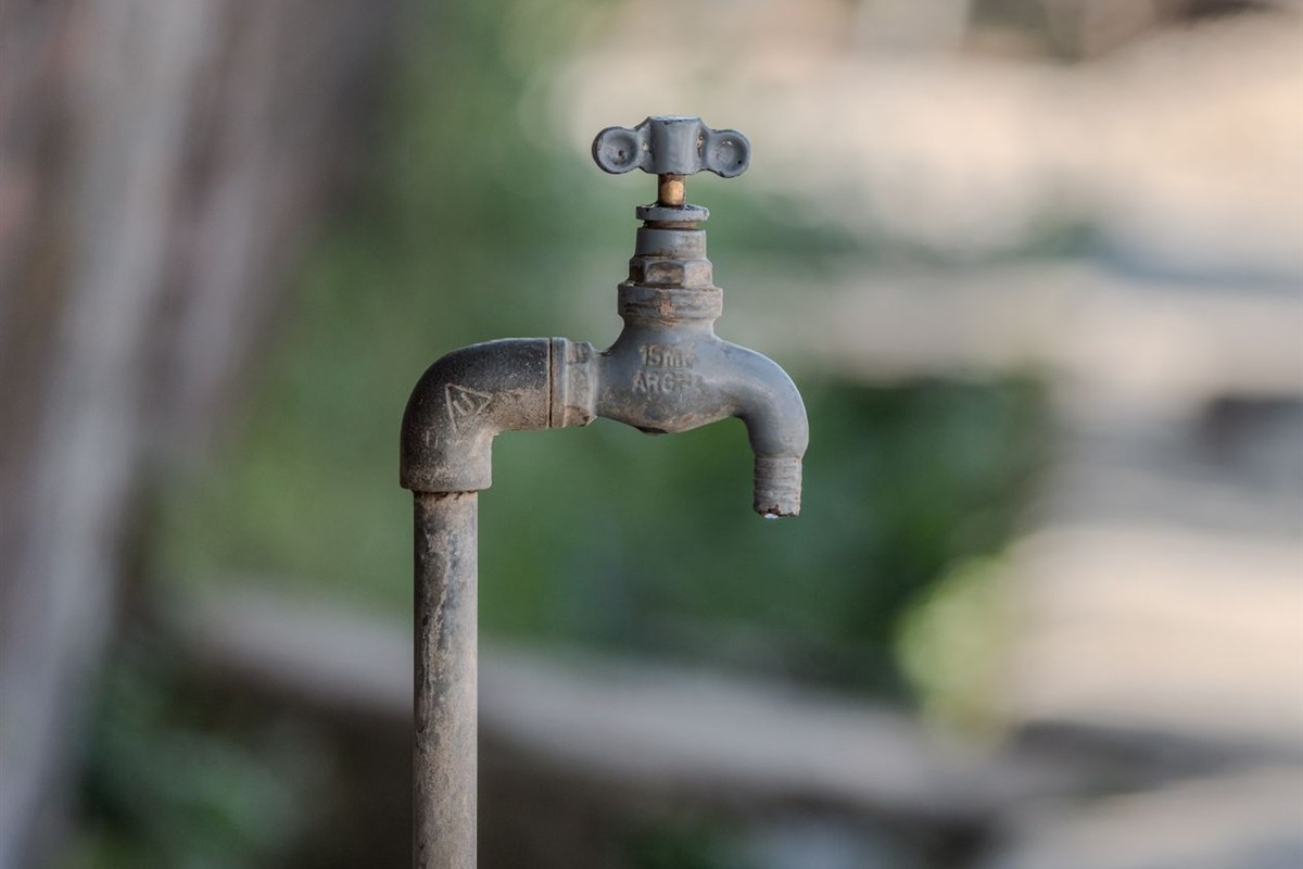 Weathered outdoor water faucet.